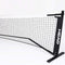 The HEAD 10 and Under Mini Tennis Net - 6.1m is a portable black and white tennis net featuring the "HEAD" logo. Designed for indoor use, it boasts a sleek and sturdy frame, making it ideal for Kids Tennis or 10 and Under Tennis practice and recreational play.