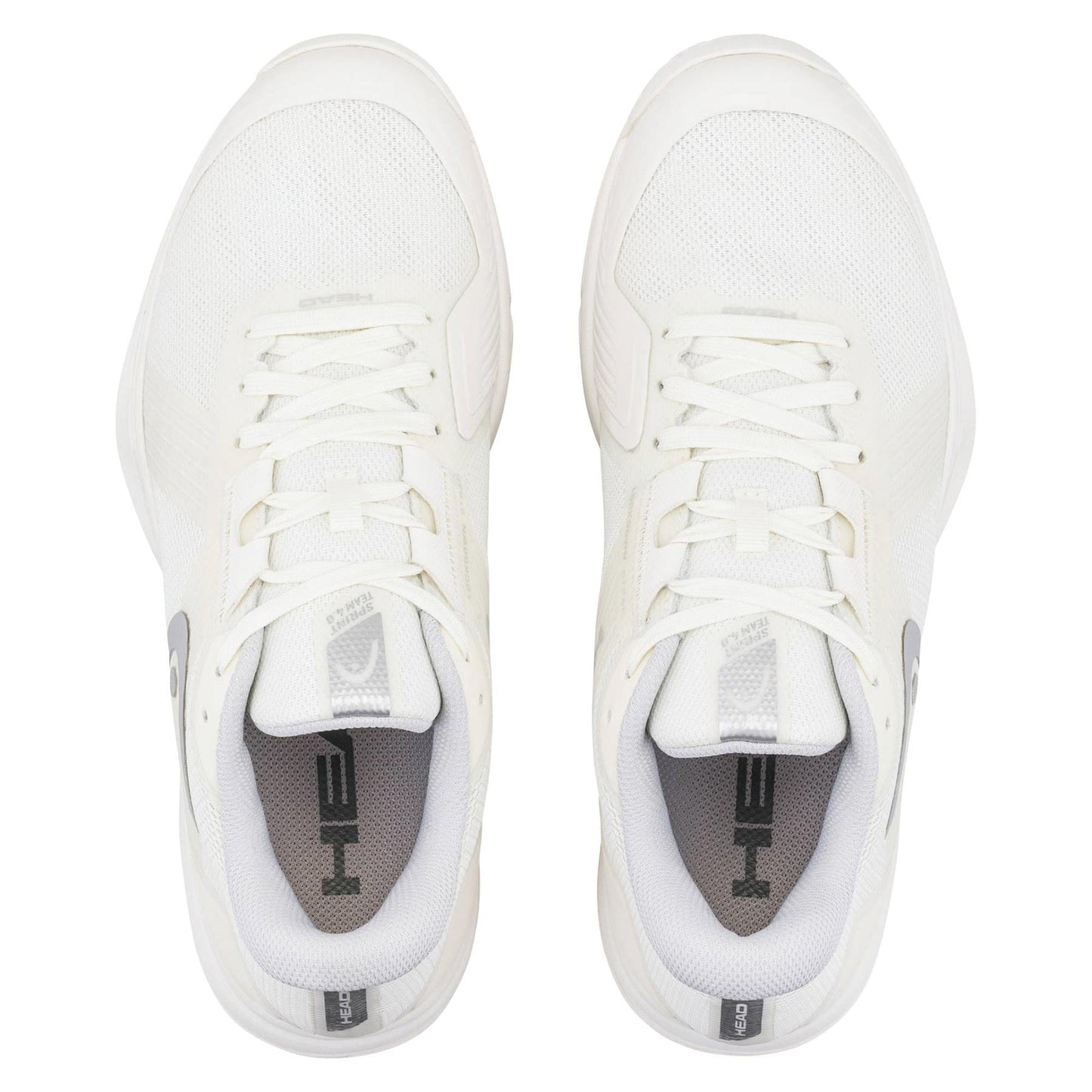 A pair of HEAD Sprint Team 4.0 Womens Tennis Shoes in Chalk White and Light Grey by HEAD, viewed from above. These lightweight shoes have white laces, "HE" on the gray insoles, and feature stylish light grey accents.
