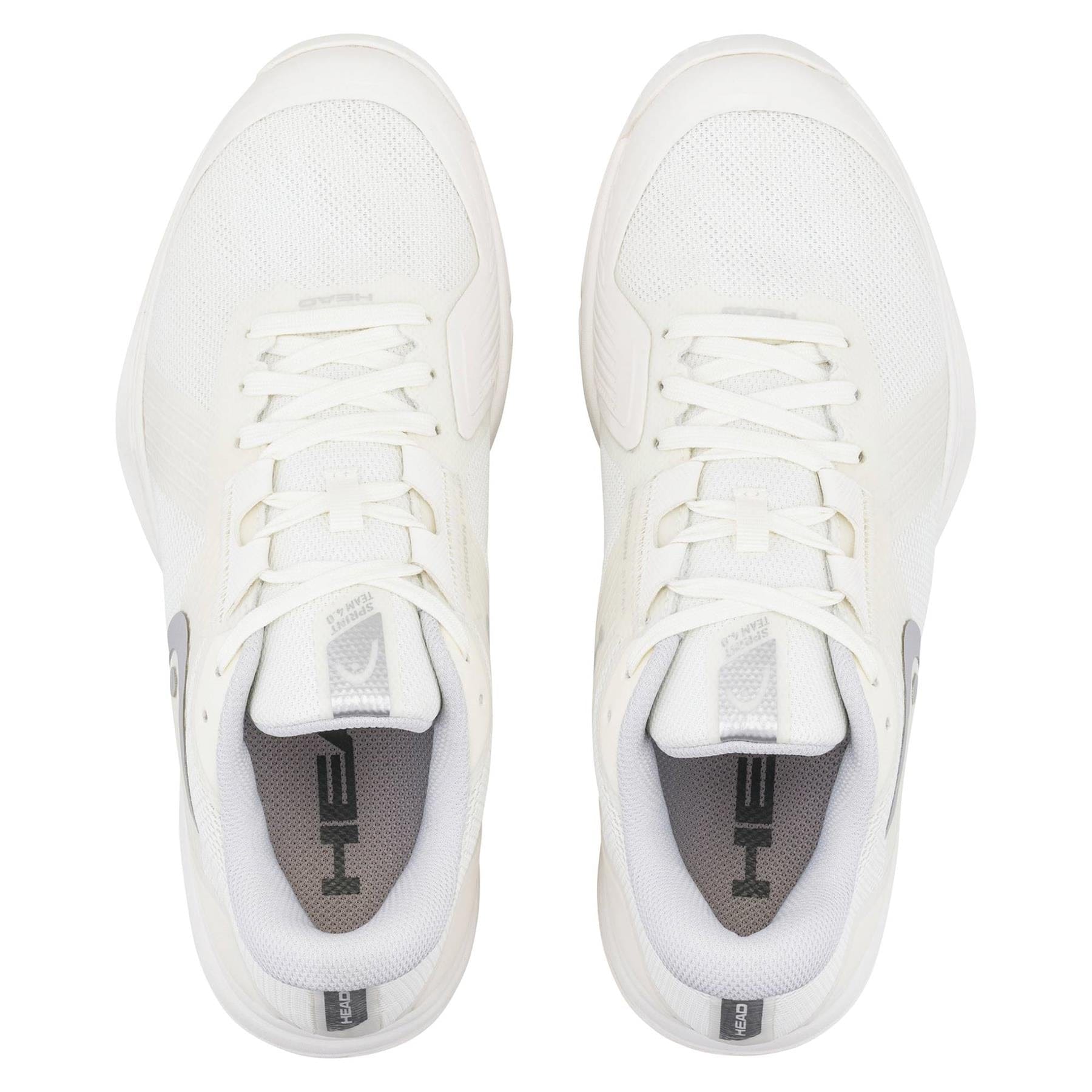 A pair of HEAD Sprint Team 4.0 Womens Tennis Shoes in Chalk White and Light Grey by HEAD, viewed from above. These lightweight shoes have white laces, "HE" on the gray insoles, and feature stylish light grey accents.