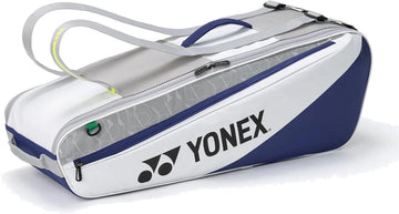 The Yonex BA52526EX Club 6 Racket Tennis Bag in white/blue features a large Yonex logo, zippered side pocket, and gray shoulder straps—ideal for carrying tennis or badminton gear.