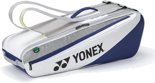The Yonex BA52526EX Club 6 Racket Tennis Bag in white/blue features a large Yonex logo, zippered side pocket, and gray shoulder straps—ideal for carrying tennis or badminton gear.