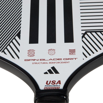 Close-up of the adidas ADIDAS Match Light 3.3 Pickleball Paddle in white with black geometric lines, "Spin Blade Grit," "Structural Reinforcement," and "USA Pickleball Approved"—ideal for beginners, featuring adidas and other logos.