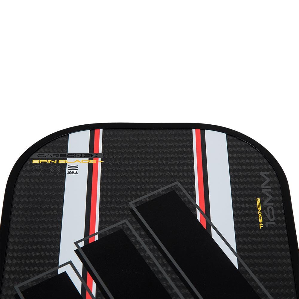 Close-up of the adidas Adipower Carbon ATTK 3.3 Pickleball Paddle (Black/White) top, showcasing a carbon fiber pattern with stripes and product text on the surface.
