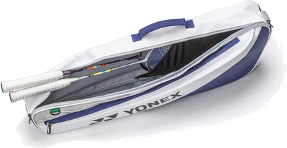 The Yonex BA52523EX Club 3 Racket Tennis Bag in white and blue is unzipped to reveal two racquets with white handles inside. Lightweight and easy to carry, this Yonex bag features a convenient top handle for transport.