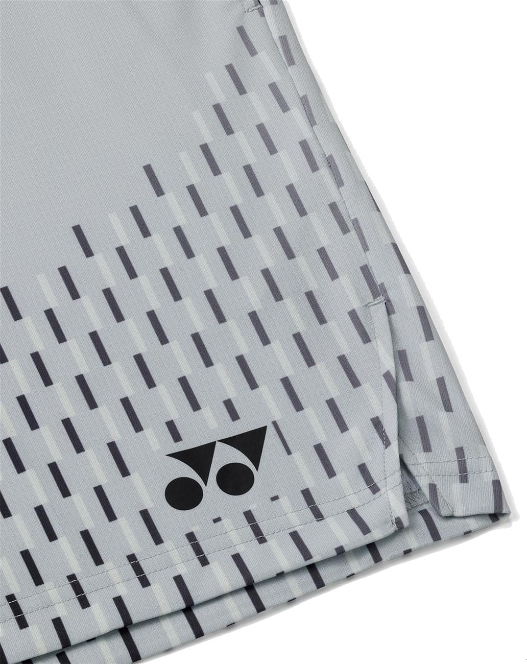 Close-up of Yonex 15241EX Knit Men's Tennis Shorts in Silver Grey, featuring geometric dark gray lines and a black Yonex logo, designed for moisture-wicking performance.