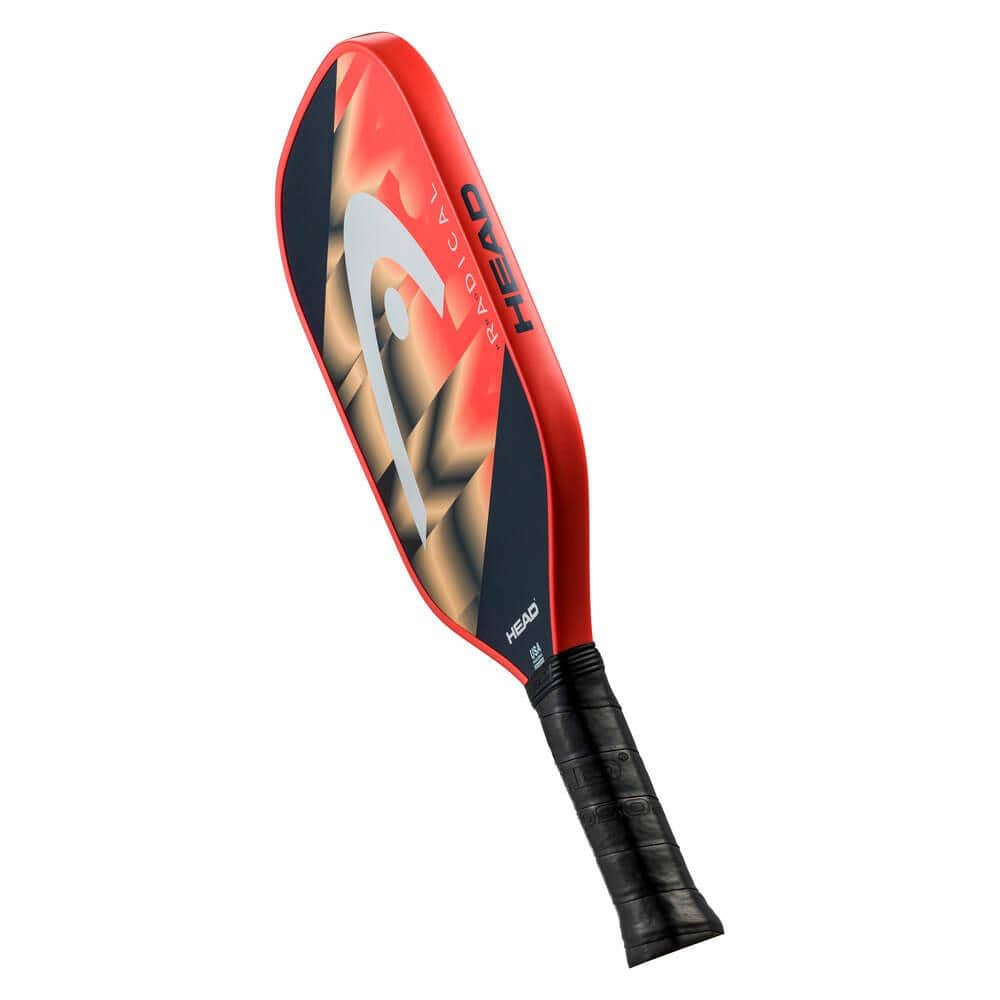 The HEAD Radical Pro Pickleball Paddle in orange and navy features a bold, modern design with a black handle, the HEAD logo on the side, and SpinOn technology for enhanced control and spin.