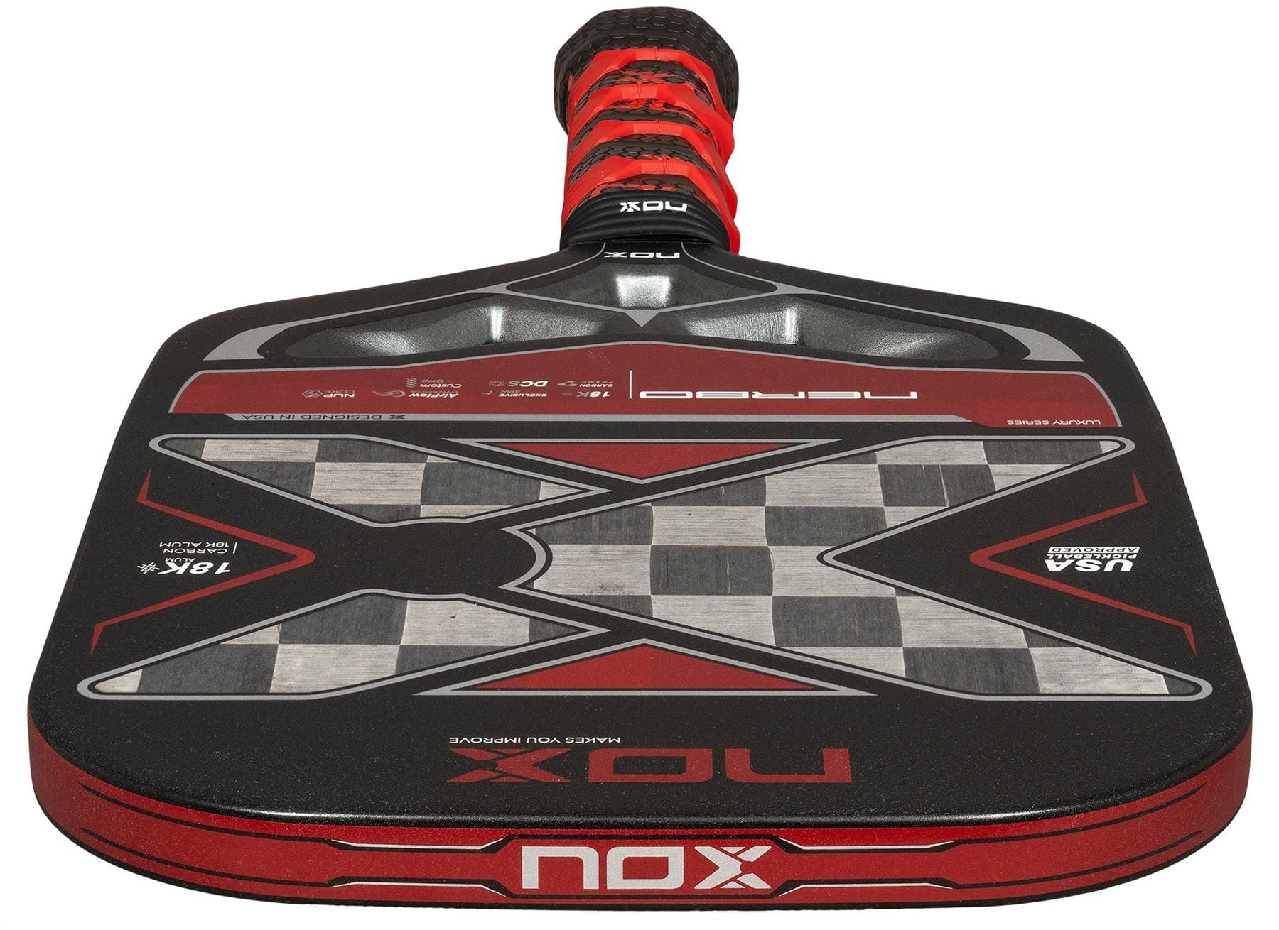 A close-up of the NOX Luxury Nerbo Pickleball Paddle by NOX, in black and red, highlighting its large “X” design, detailed graphics, aluminised carbon fibre surface, and textured grip handle.
