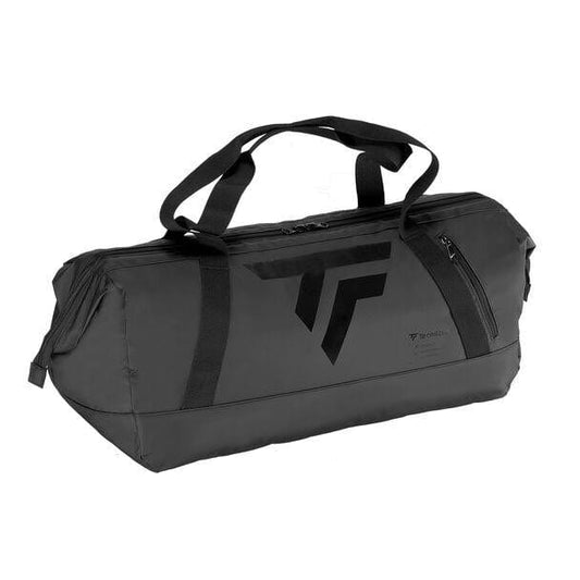 The Tecnifibre Tour Endurance Tennis Duffle Bag - Ultra Black is a stylish sports accessory featuring dual handles and a secure zipper closure. Its waterproof construction and tear-resistant Tarpaulin material ensure long-lasting durability. The bag prominently displays a large, bold logo on the side and includes a convenient side pocket for quick access.