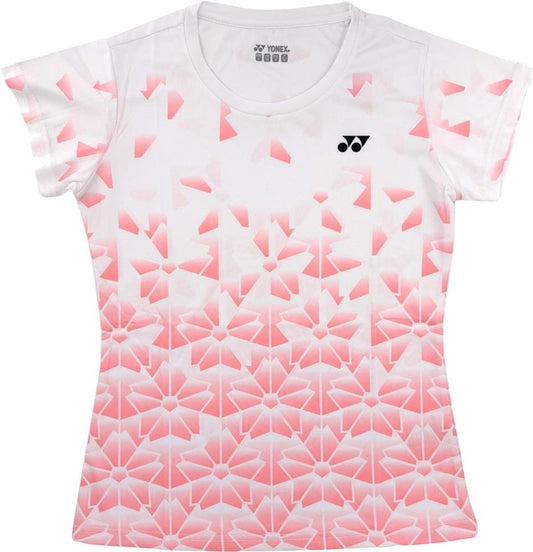 The Yonex YTL2025B Womens Tennis T-Shirt in white features short sleeves, a pink geometric floral fade, breathable sports fabric, and a small Yonex logo on the left chest.