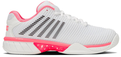 The K-Swiss Hypercourt Express 2 Women's Tennis Shoes in White/Pastel Pink/Black feature a ribbed texture, black stripes, pink accents on the heel, midsole & laces, and a treaded white outsole for cushioning and stability.