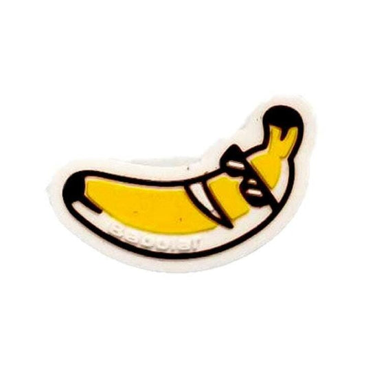 The Babolat Loony Damp Tennis Dampener - Banana features a cartoon-style yellow banana with a black outline, brown stem, and black superhero mask—adding fun to your racket while helping reduce vibrations on the court.