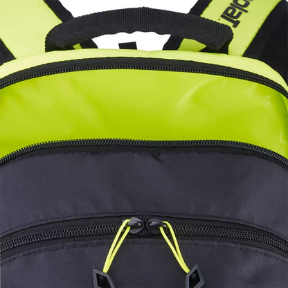 Close-up of the Babolat Kids Tennis Backpack in Metallic Grey and Fluo Yellow, featuring a black front compartment with bright yellow zipper pulls and a bold yellow top section with black straps—making it a stylish choice for young tennis players.