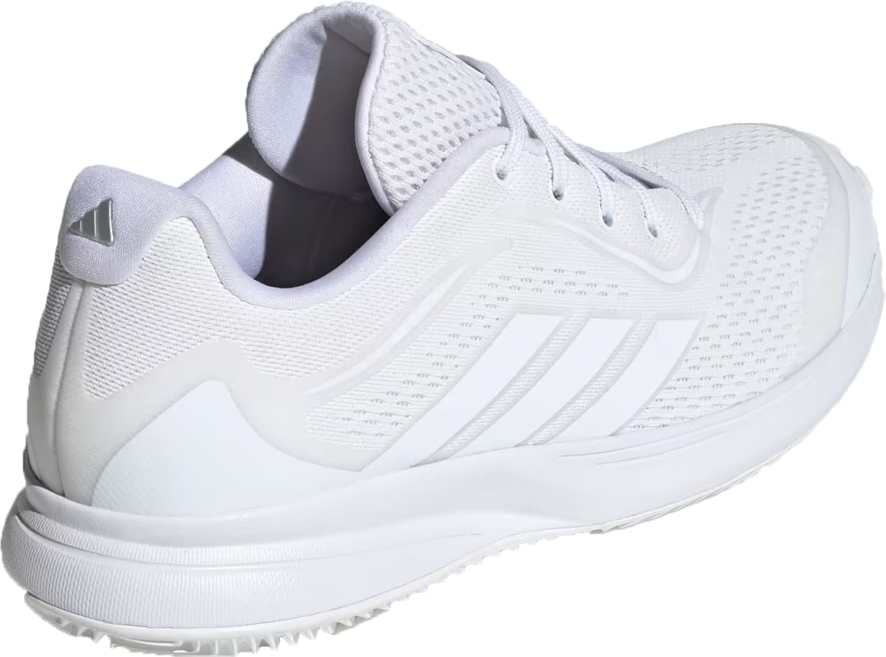 The adidas AvaFlash 2 Women’s Tennis Shoes in Cloud White/Silver Metallic feature a white mesh upper with subtle stripes, a raised sole, padded tongue and collar, heel logo, and lightweight comfort for stylish performance on the court.