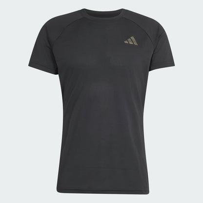 A plain black adidas Climacool+ Freelift Pro Men’s Tennis T-Shirt featuring a small, light-colored adidas logo on the left chest is displayed on a white background. This shirt is designed for comfort and breathability both on and off the court.