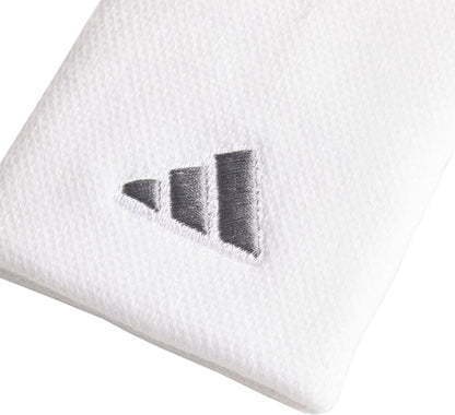 Close-up of a white textured fabric featuring adidas’ three-striped triangular logo, showcasing the adidas Large Tennis Wristband - White.