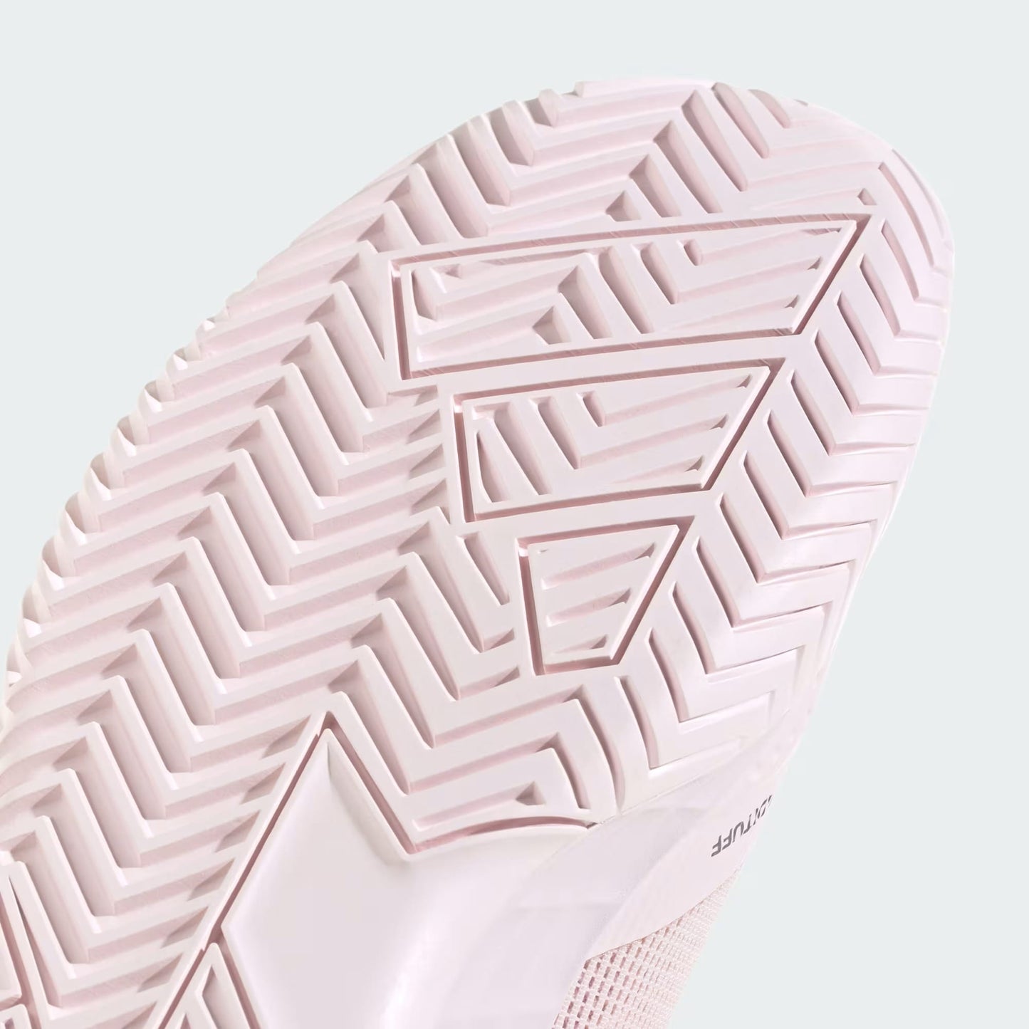 Close-up of the sole of the adidas Defiant Speed 2 Womens Tennis Shoes in Distilled Pink, showcasing a bold geometric zigzag tread pattern and “Adiwear” embossed on the lower right side, emphasizing these lightweight adidas tennis shoes for women.