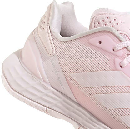 Close-up of the adidas Defiant Speed 2 Women’s Tennis Shoes in Distilled Pink, featuring soft pink tones with white accents, textured details, and a partially visible sole displaying the tread pattern—these women’s tennis shoes from adidas deliver an ideal balance of style and performance. The lightweight construction ensures comfort both on and off the court.