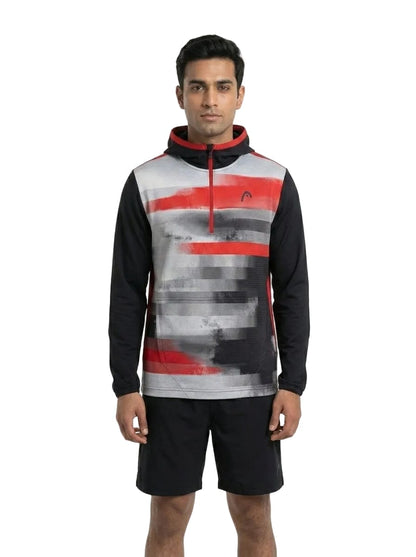 A man stands facing forward in a HEAD Vision Topspin Mens Tennis Hoodie - BKXV by HEAD—a black and gray long-sleeve men’s sports hoodie with red stripes—paired with black shorts, set against a plain white background.