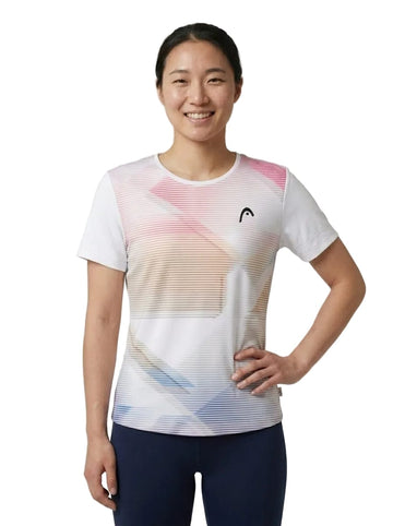A woman smiles, standing with one hand on her hip, wearing the HEAD Tie-Break II Women’s Tennis T-Shirt - LBXW by HEAD—a vibrant short-sleeve athletic top showcasing subtle pink, beige, and blue stripes with a small black logo on the chest. This breathable shirt is ideal for staying cool and comfortable during any activity.