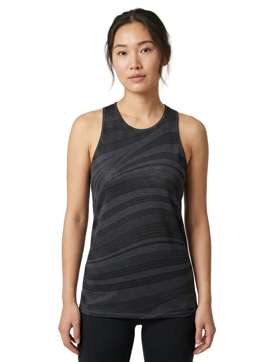 A woman is wearing the adidas ADIDAS Womens Club Graphic Tennis Tank Top in black, styled with black leggings and standing against a plain white background.
