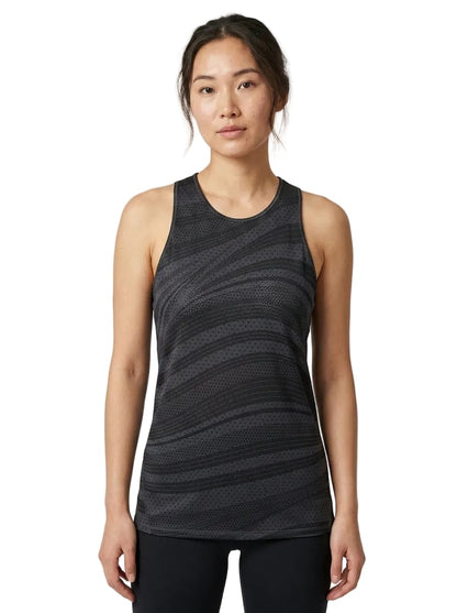 A woman is wearing the adidas ADIDAS Womens Club Graphic Tennis Tank Top in black, styled with black leggings and standing against a plain white background.