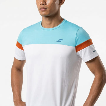 A man wearing the Babolat Crew Neck Men’s Tennis T-Shirt in white stands with his arms relaxed at his sides against a plain white background.