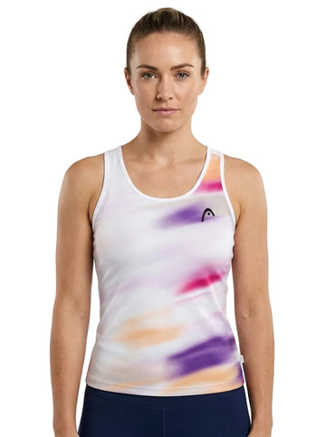 A woman stands facing forward against a plain white background, modeling the HEAD Blur Womens Tennis Tank Top - PUXU by HEAD—an innovative piece of moisture-wicking sportswear featuring a white base with purple, pink, and orange streaks, designed specifically as a women’s tennis tank top.