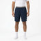 HEAD Performance Mens Tennis Shorts in navy with a 4-way stretch fabric and striped waistband, worn with a white t-shirt and white socks.