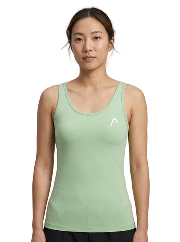 A woman with tied-back hair wears the HEAD Spirit II Women’s Tennis Tank Top in Celeste, featuring advanced cooling technology, and stands facing forward against a white background.