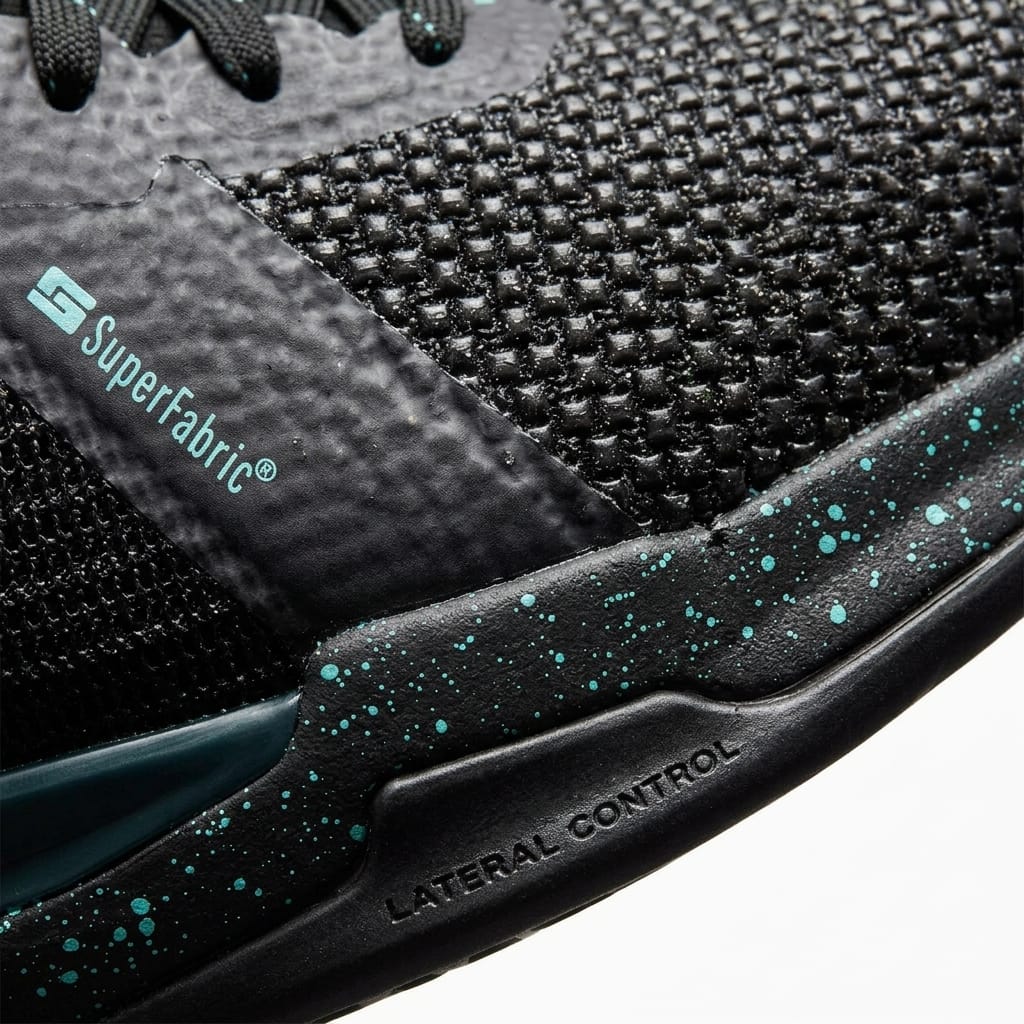 Close-up of HEAD Sprint Pro 4.0 SF Men's Tennis Shoes in Black/Teal, featuring textured mesh, speckled teal midsole, and visible SuperFabric® and Lateral Control branding for enhanced durability and performance.