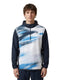 A person wearing the HEAD Topspin Mens Tennis Hoodie - NVXU by HEAD, featuring a navy and white color scheme with a blue and white abstract front pattern, stands against a plain white background.