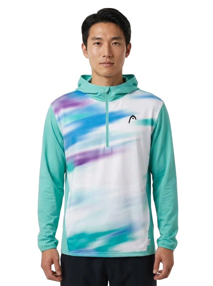 A man stands facing forward in the HEAD Topspin Mens Tennis Hoodie - TQXU by HEAD, showcased in teal and white with striking purple and blue streaks. This sportswear hoodie features a half-zip front, a small HEAD logo on the left chest, and blends modern style with moisture-wicking comfort for active individuals.