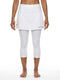 A person stands barefoot against a plain white background, wearing the HEAD Womens Club 3/4 Tights Tennis Skort in white by HEAD—an athletic skirt layered over matching capri-length tights made from moisture-wicking microfibre.