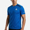 A man is wearing the Le Coq Sportif Pro Mens Tennis T-Shirt in Lapis Blue, featuring the “Le Coq Sportif” logo on the chest and left sleeve, while standing against a plain white background. This performance t-shirt from Le Coq Sportif offers a breathable fit, making it ideal for active play.