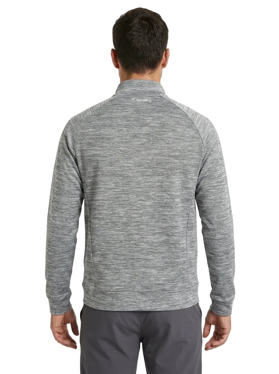 A man is standing with his back to the camera, wearing a Tecnifibre Men’s Team Tennis Jacket in Silver and gray pants. The lightweight, breathable jacket by Tecnifibre features long sleeves and a stand collar. The background is plain white.