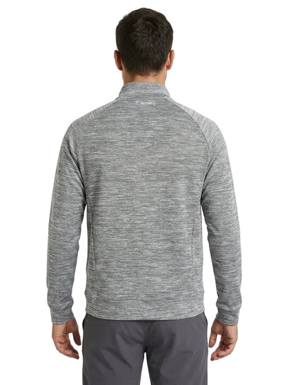 A man is standing with his back to the camera, wearing a Tecnifibre Men’s Team Tennis Jacket in Silver and gray pants. The lightweight, breathable jacket by Tecnifibre features long sleeves and a stand collar. The background is plain white.