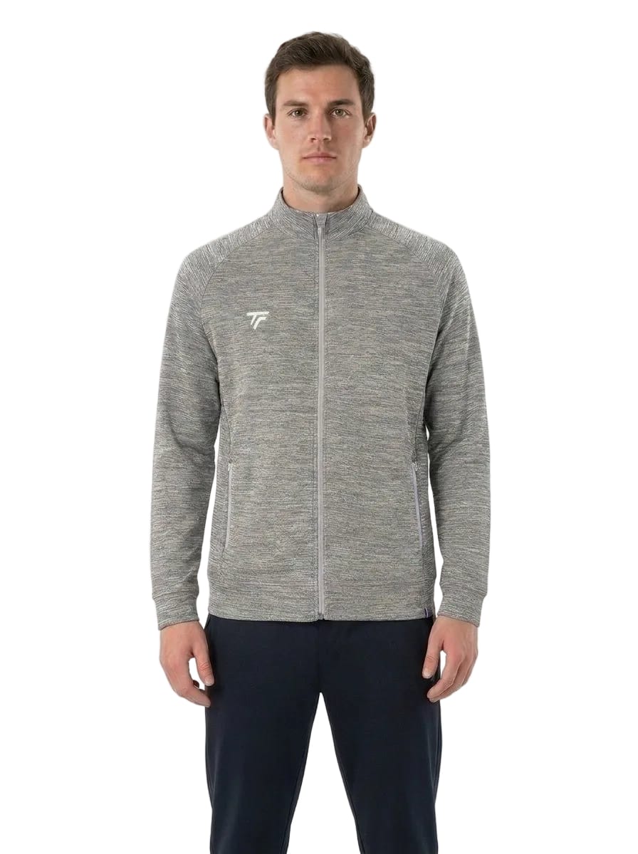 A man wearing a Tecnifibre Men’s Team Tennis Jacket in Silver, featuring a lightweight, breathable design with a small white Tecnifibre logo on the left chest, paired with dark pants and standing against a plain white background.