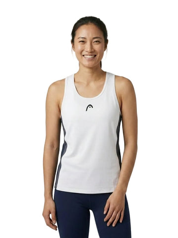 A smiling woman faces the camera against a white background, wearing the HEAD Club 25 Tech Women’s Tennis Tank Top in navy and white along with dark leggings. Featuring a racerback design and moisture-wicking fabric, this HEAD tank top offers comfort and style for any athletic activity.