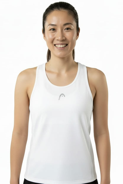 Smiling woman with dark hair tied back poses against a plain white background, wearing the HEAD Club 25 Tech Women’s Tennis Tank Top in white—a sleeveless design featuring a small gray HEAD logo on the front and a sporty racerback for enhanced comfort.