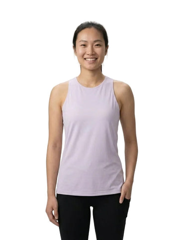 A woman wearing the adidas ADIDAS Womens Club Tennis Tank Top in pink, made from recycled materials, and black pants stands smiling against a plain white background.