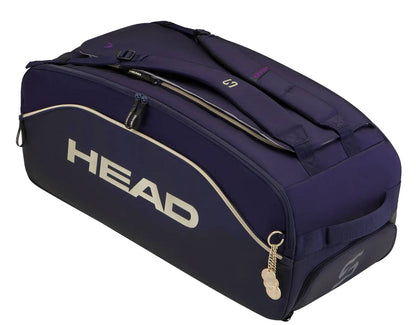 The HEAD Pro X Zverev LTD Tennis Duffle Bag L - Navy by HEAD is a spacious navy tennis bag inspired by Alexander Zverev. Featuring cream trim, white HEAD logo, zippered compartments, adjustable straps, and a keychain detail on the zipper, this stylish duffle is designed for both functionality and flair.