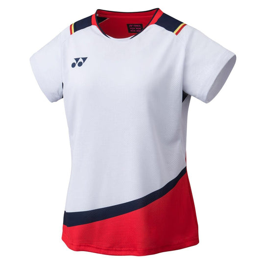The Yonex 20685 Womens Shirt - White is a sports jersey featuring short sleeves, red and navy blue accents, and UV reduction technology. It includes a discreet brand logo on the left chest along with a striking red diagonal stripe across the bottom. The neckline is elegantly trimmed with navy blue and accented with subtle red details.