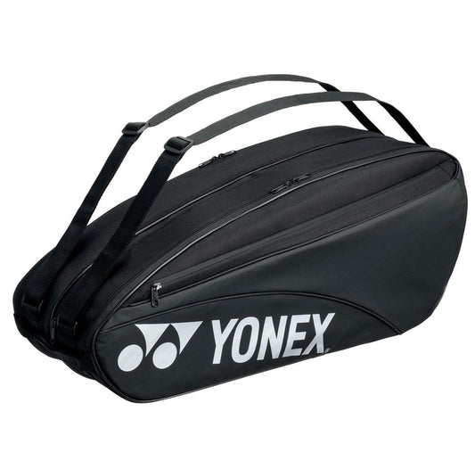 Introducing the Yonex 42326EX 6 Piece Racket Bag in black, showcasing a sleek design adorned with the iconic Yonex logo in white. This bag features adjustable shoulder straps, a convenient wet compartment, and multiple zippered compartments for optimal storage.