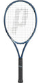 A Prince O3 Legacy 110 270g tennis racket by Prince, characterized by its blue frame, black handle, and white strings with TeXtreme technology. The Prince logo is prominently displayed on both the strings and handle. Renowned for its large sweetspot, the racket is shown standing vertically against a plain backdrop.