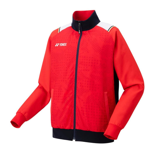 The Yonex 70090 Tracksuit Warm-Up Jacket in ruby red features long sleeves and a zip-up front. This stylish sportswear, equipped with ANTISTATIC properties, showcases a patterned design on the front along with the iconic logo on the chest, making it perfect for vibrant energy during any athletic activity.