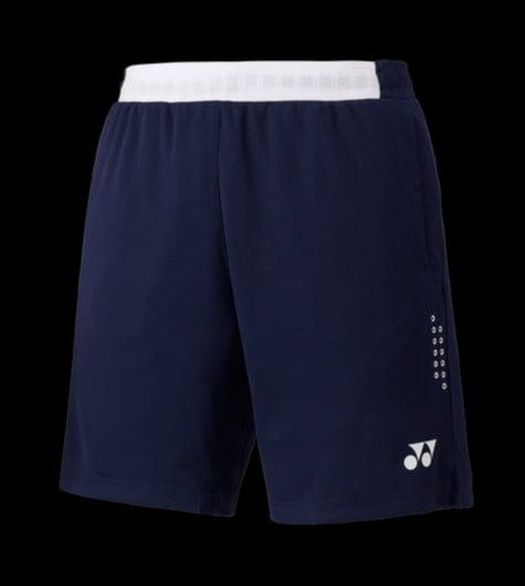 The Yonex 15131 Men's Shorts - Navy Blue showcase a stylish navy blue appearance with a contrasting white waistband, adorned with a small logo on the left and understated white dots on the right. Featuring advanced Very Cool technology for UV reduction, these shorts provide both comfort and style in any athletic environment. The background is black.