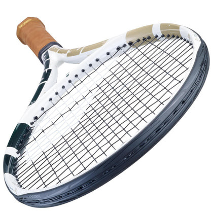 Close-up view of the Babolat Pure Drive Team Tennis Racket - Wimbledon, showcasing its white frame, black strings, and brown grip handle equipped with SWX Pure Feel technology, set against a plain white background.