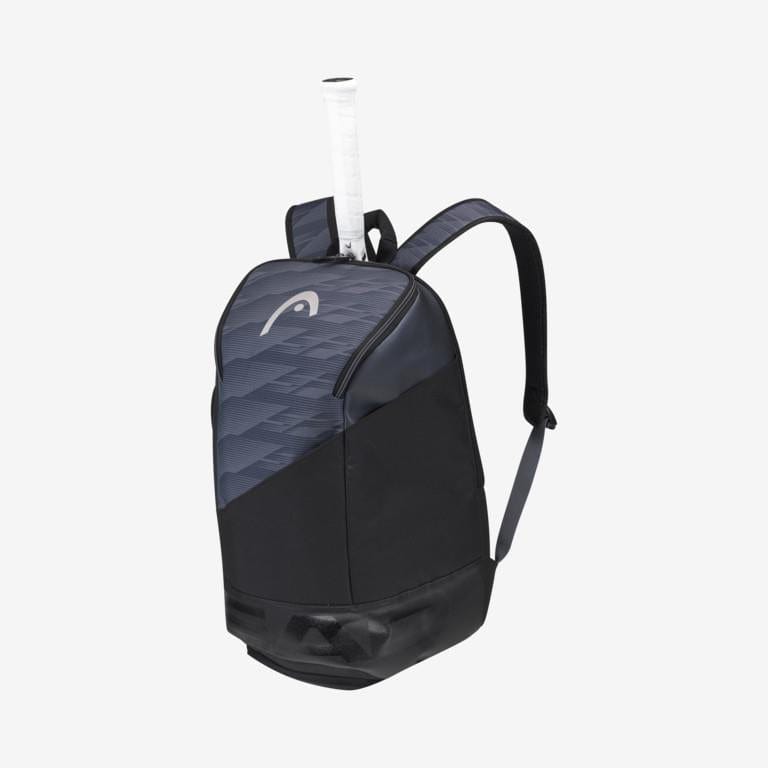 The HEAD Djokovic Tennis Backpack in Black/Grey showcases a partially visible tennis racket handle from its padded racket compartment. It includes adjustable shoulder straps, a subtle geometric pattern on the top section, and a ventilated shoe compartment for extra convenience.