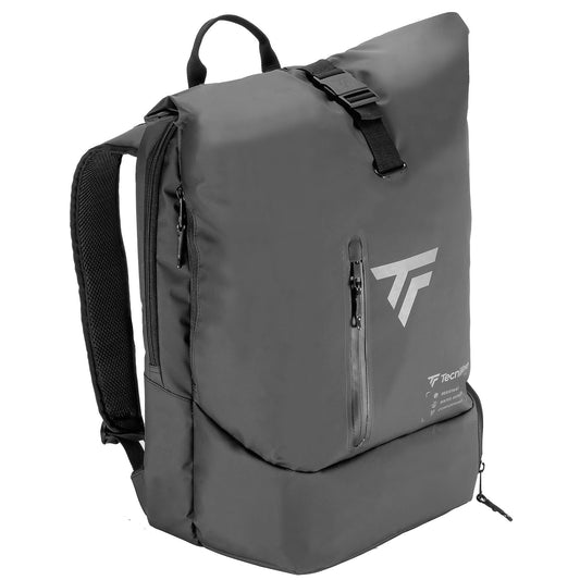 The Tecnifibre Team Dry Standing Tennis Backpack in black is a stylish, modern bag designed with a roll-down top closure secured by a buckle. It includes a front zippered pocket, adjustable shoulder straps, and a prominently displayed branded logo. Crafted from durable tarpaulin, this waterproof backpack is ideal for both outdoor and urban adventures.