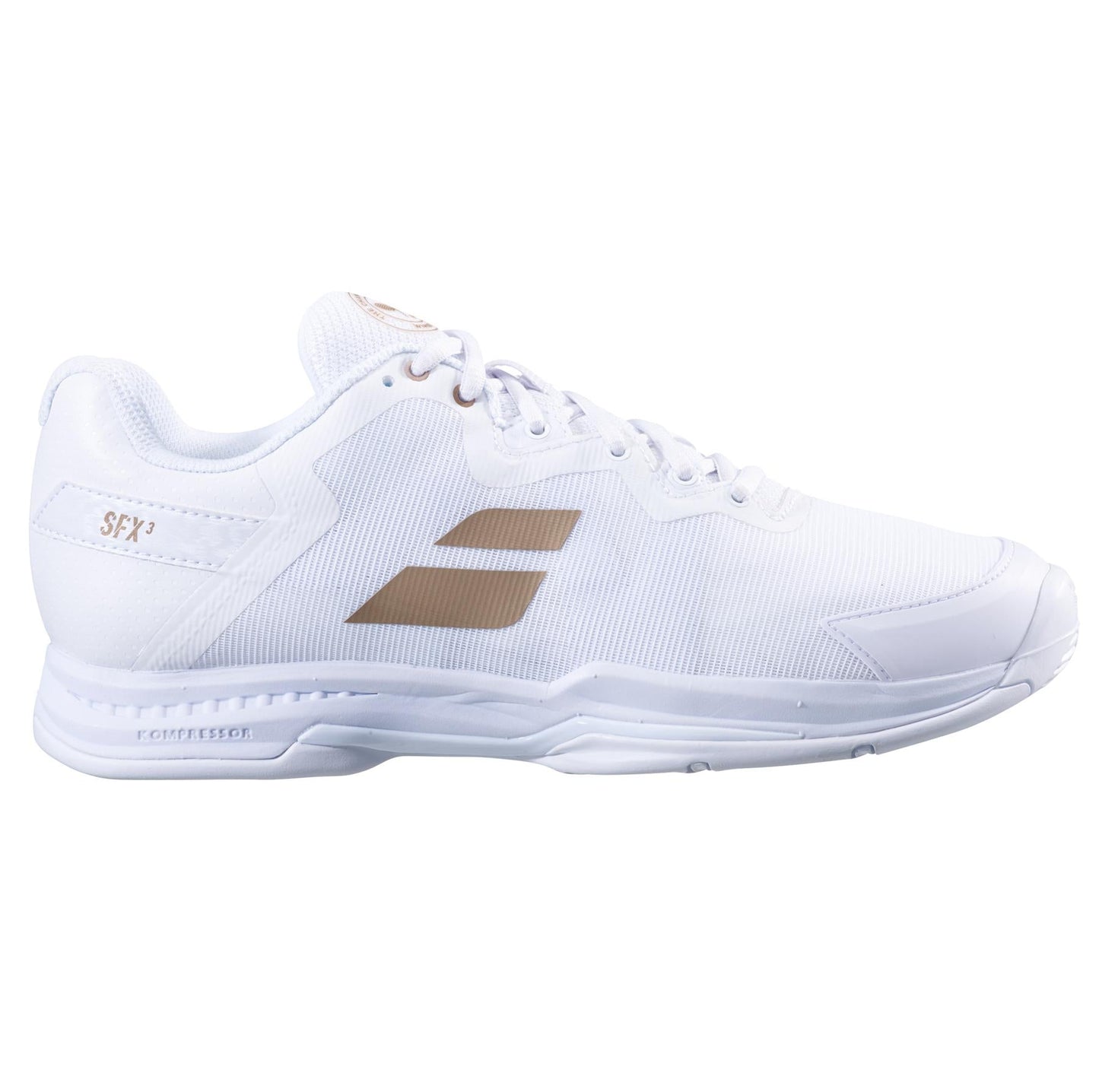 A sleek athletic shoe with a white design enhanced by gold accents and the Babolat brand name on the side. It features a Kompressor System for improved cushioning, a textured sole, and white laces—a perfect mix of style and performance, making it ideal for any sports enthusiast.